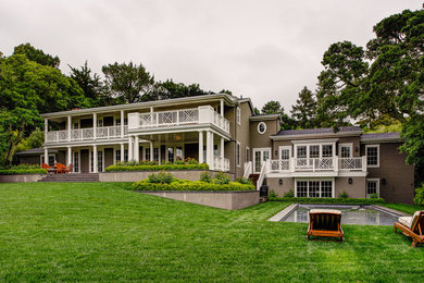Inspiration for a large timeless gray two-story wood exterior home remodel in San Francisco with a shingle roof