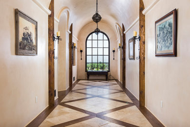 Tuscan hallway photo in Santa Barbara with beige walls