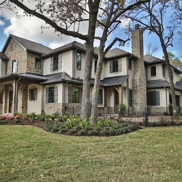 Combining Stucco and Stone bring charm to this Country French