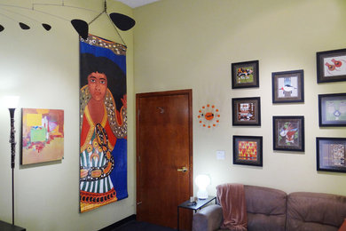 Example of a small eclectic carpeted home office design in Denver with green walls