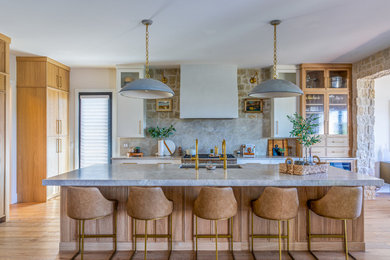 Inspiration for a large country l-shaped open concept kitchen remodel with shaker cabinets, light wood cabinets, quartzite countertops, an island and multicolored countertops