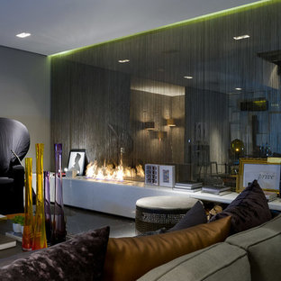 This is an example of a small modern open plan home cinema in Other with grey walls, marble flooring and a wall mounted tv.