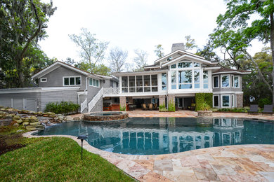 This is an example of a large transitional backyard custom-shaped pool in Atlanta with a hot tub and tile.