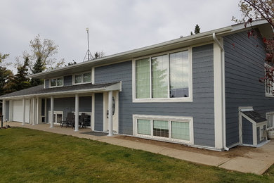 Inspiration for a transitional blue concrete fiberboard exterior home remodel with a shingle roof