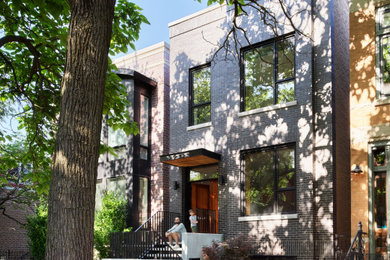Modern black three-story brick exterior home idea in Chicago
