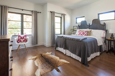 Bedroom - large transitional guest medium tone wood floor bedroom idea in Dallas with white walls and no fireplace