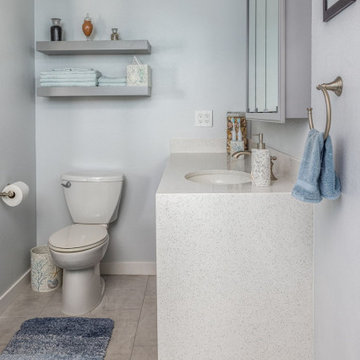 Coastal mater bathroom remodel with waterfall edge and walk in shower