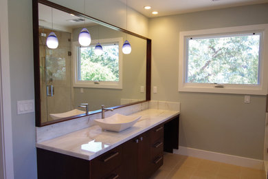 Large traditional master bathroom in San Francisco with a vessel sink, flat-panel cabinets, medium wood cabinets, marble benchtops, a corner shower, green walls and porcelain floors.