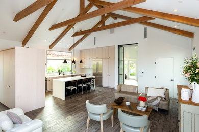 Inspiration for a mid-sized contemporary open concept medium tone wood floor and brown floor living room remodel in Los Angeles with white walls, no fireplace and no tv