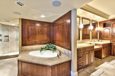 Large elegant master beige tile and porcelain tile porcelain tile drop-in bathtub photo in Miami with raised-panel cabinets, medium tone wood cabinets, beige walls, an undermount sink and granite countertops