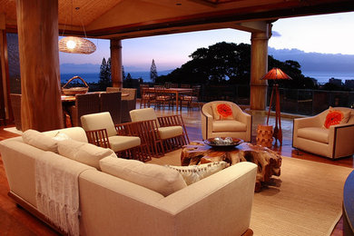 Example of a large island style open concept medium tone wood floor living room design in San Francisco with brown walls