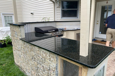 Example of a mid-sized mountain style backyard patio kitchen design