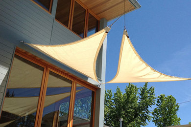 Inspiration for a mid-sized transitional backyard concrete patio remodel in Boise with an awning