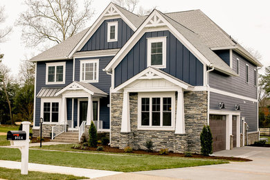 Large transitional blue two-story mixed siding house exterior photo in Other with a hip roof and a shingle roof