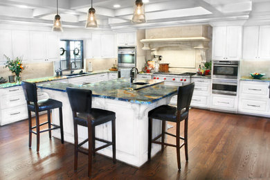 Trendy u-shaped eat-in kitchen photo in Austin with raised-panel cabinets, white cabinets, soapstone countertops, stone tile backsplash, stainless steel appliances and an undermount sink