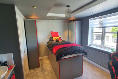 Photo of a medium sized modern guest and grey and silver bedroom in Other with grey walls, carpet, grey floors, a coffered ceiling and feature lighting.