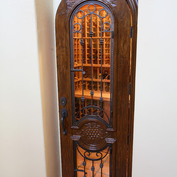 Arched Wine Cellar Door with Glass Insert and Wrought Iron Bars