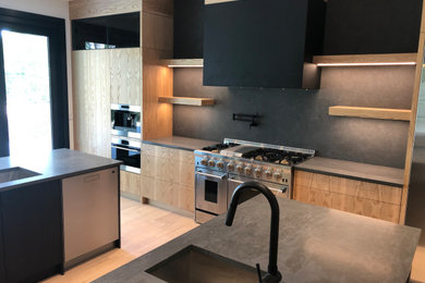 Example of a large minimalist u-shaped light wood floor and brown floor eat-in kitchen design in Calgary with a double-bowl sink, flat-panel cabinets, brown cabinets, quartz countertops, gray backsplash, marble backsplash, stainless steel appliances, an island and gray countertops