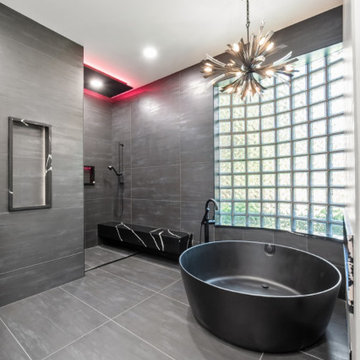 Sleek Master Bathroom with Curved Glass Block Window and Open Shower