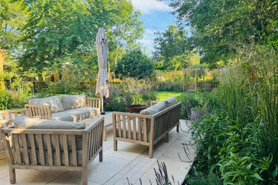 Design ideas for a country back patio in Berkshire with natural stone paving.