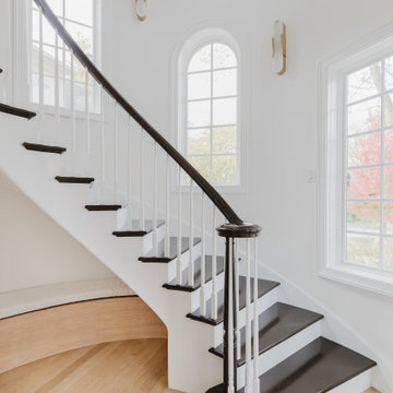 Graceful Stair Hall with Arched Windows and Curved Handrail