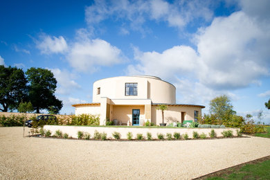 Large modern two-storey stucco house exterior in Dorset with a flat roof.