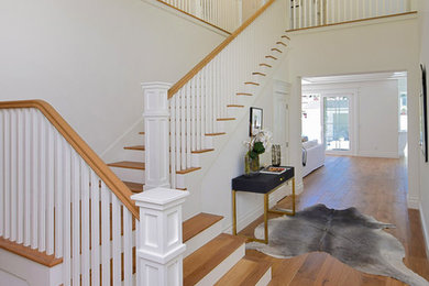 Mid-sized traditional wood l-shaped staircase in Los Angeles with painted wood risers.