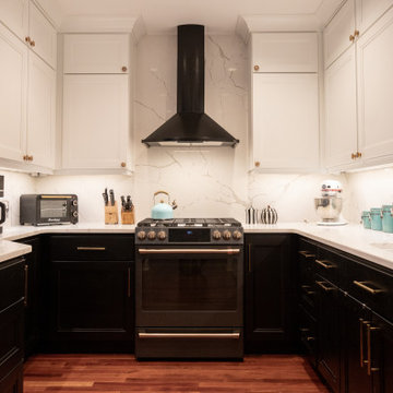 Black Kitchen Range & Hood with Quartz Counters and Shaker Storage