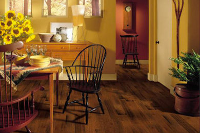 Inspiration for a mid-sized farmhouse dark wood floor and brown floor enclosed dining room remodel in Phoenix with yellow walls and no fireplace