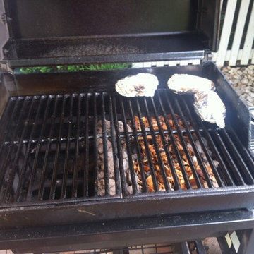 CharBQ with charcoal and wood chips under cooking grill.