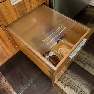 Photo of a mid-sized contemporary l-shaped kitchen pantry in Toronto with flat-panel cabinets, medium wood cabinets, quartz benchtops, white splashback, ceramic splashback, coloured appliances, ceramic floors and with island.