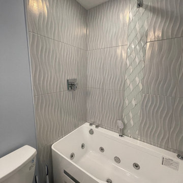 Tub Surround with Wavy 12x24 tiles and waterfall done by DESTIN ELITE TILE!