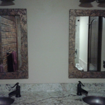 opposing shaped mirrors master bath-copper