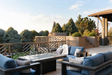 Huge trendy tile metal railing back porch idea in Denver