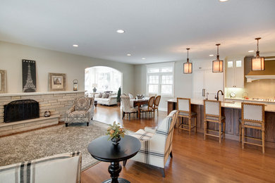 Inspiration for a timeless dark wood floor kitchen remodel in Minneapolis with an undermount sink, flat-panel cabinets, white cabinets, quartzite countertops, beige backsplash, glass sheet backsplash and paneled appliances