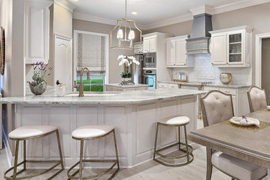 Eat-in kitchen - mid-sized transitional u-shaped porcelain tile and gray floor eat-in kitchen idea in Other with raised-panel cabinets, white cabinets, granite countertops, white backsplash, marble backsplash, an island, multicolored countertops, an undermount sink and stainless steel appliances