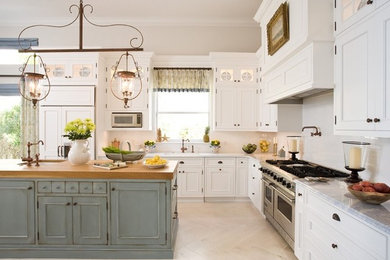 Example of a large eclectic l-shaped light wood floor and brown floor kitchen design in Tampa with an undermount sink, recessed-panel cabinets, white cabinets, granite countertops, white backsplash, subway tile backsplash, paneled appliances and an island