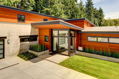Inspiration for a large contemporary two-story mixed siding exterior home remodel in Portland with a metal roof