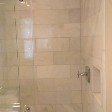 BATHROOM - Calcutta Gold Marble Shower / Gray Penny Tile Floor