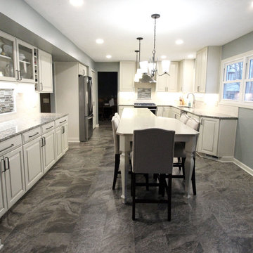 Beige Kitchen with Extra Large Island, Tile Backsplash and Granite Countertops