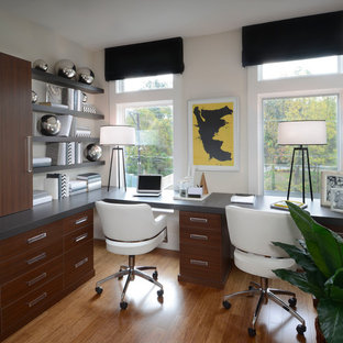 Photo of a small contemporary study room in DC Metro with bamboo floors and a built-in desk.