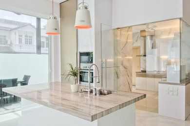 Large trendy l-shaped marble floor eat-in kitchen photo in Singapore with a single-bowl sink, flat-panel cabinets, white cabinets, marble countertops and stainless steel appliances