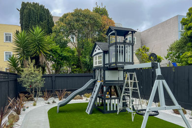 This is an example of a mid-sized modern backyard gravel and wood fence outdoor playset in San Francisco.