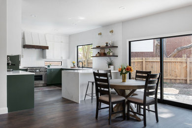 Large transitional u-shaped dark wood floor and brown floor open concept kitchen photo in Austin with an undermount sink, shaker cabinets, green cabinets, quartz countertops, white backsplash, porcelain backsplash, stainless steel appliances, a peninsula and white countertops