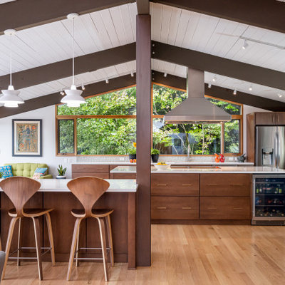 Mid-sized 1960s light wood floor, beige floor and exposed beam open concept kitchen photo in Other with an undermount sink, flat-panel cabinets, brown cabinets, quartz countertops, green backsplash, mosaic tile backsplash, stainless steel appliances, an island and white countertops