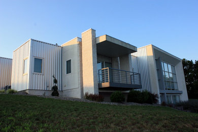 Example of a large minimalist white two-story mixed siding exterior home design in Philadelphia