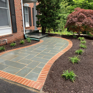 Limestone walkway with brick ascent to match house