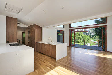 Eat-in kitchen - large modern galley medium tone wood floor and vaulted ceiling eat-in kitchen idea in Portland with an undermount sink, flat-panel cabinets, medium tone wood cabinets, wood countertops, no island and white countertops