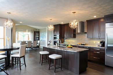 Inspiration for a large transitional single-wall slate floor and gray floor open concept kitchen remodel in Cincinnati with an undermount sink, shaker cabinets, dark wood cabinets, granite countertops, gray backsplash, mosaic tile backsplash, stainless steel appliances and an island