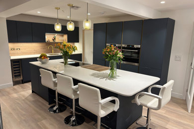 Fjord Blue true handle-less kitchen with White quartz worktops